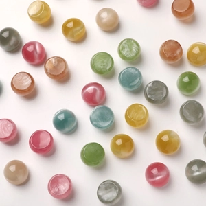 Macro shot of 16mm iridescent resin cabochons with cat-eye effect for DIY jewelry making