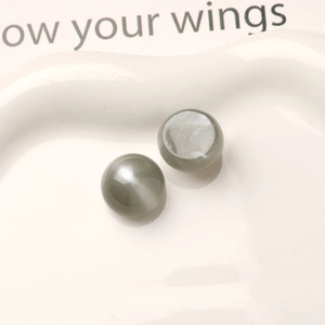 Macro shot of 16mm grey resin cat eye beads with starry shimmer for DIY jewelry making