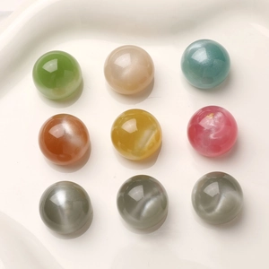 Close-up of 16mm dreamy starry sand resin beads with cat eye effect for DIY jewelry