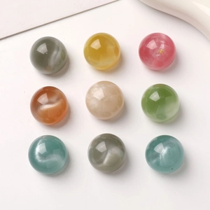 Set of nine colorful 16mm round resin beads with shimmering starry sky sand effect