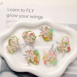 Detail of DIY floral pendants with frosted glass petals and pearls on white tray