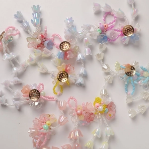 Macro detail of colorful gradient lily of the valley beads with crystal pearlescent finish