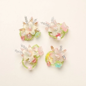 Macro shot of handmade gradient resin flower pendants with colorful glass beads