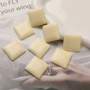 Macro detail of cream square resin cabochons for DIY jewelry and hair accessories