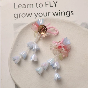 Macro view of crystal lily of the valley tassel earrings with pearlescent pink and blue petals