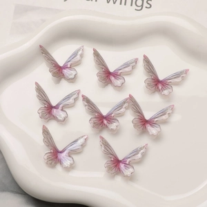Macro detail of 3D gradient resin butterflies with silver glitter for DIY jewelry making