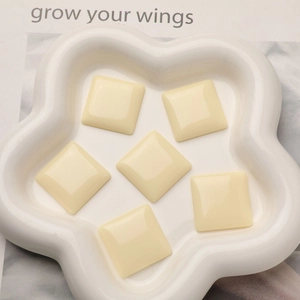 Macro shot of 6 pieces cream square resin cabochon charms for DIY jewelry making