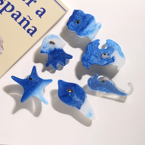 Blue and white resin ocean-themed knobs featuring starfish and sea creature shapes