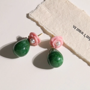 Detail of vintage resin flower earrings with pink roses, pearls and green teardrop charms