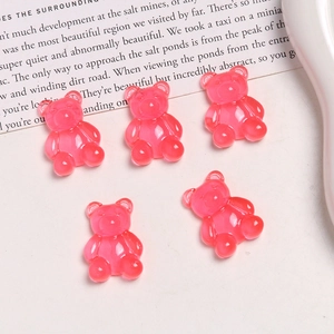 Close-up of translucent pink gummy bear resin charms for DIY jewelry and crafts