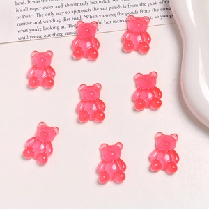 Macro shot of 8 translucent pink resin gummy bears for DIY jewelry and accessories