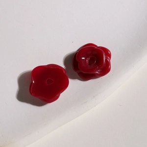 Macro shot of dark red resin flower charms showing multi-layer petals and center hole