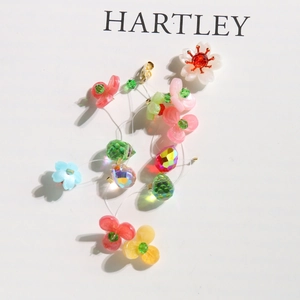 Floral charm with colorful resin flowers and crystal beads on a golden clasp hanging accessory