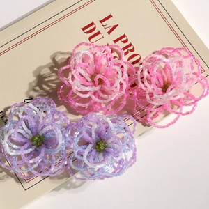 Detailed view of handmade beaded flower accessories in gradient pink and purple tones