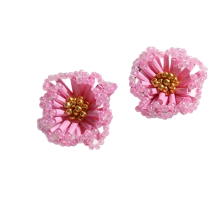 Pink beaded flower earrings with golden seed centers and transparent petal accents