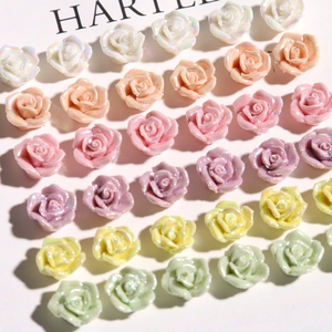Detail view of pearlescent resin rose flowers for DIY jewelry making and nail art design