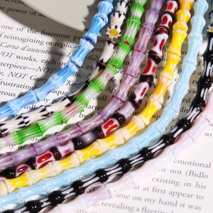 Macro detail of multicolored lampwork glass beads in bamboo shape for DIY jewelry