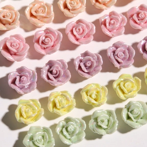 Macro shot of macaron-colored resin rose flower accessories with pearlescent finish