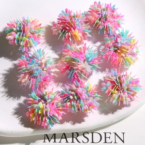 Macro detail of colorful floral DIY bead clusters with vibrant multi-color sequins