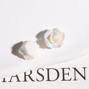 Macro shot of iridescent resin rose flower charms for DIY jewelry and crafts making