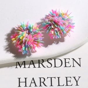 Close-up of colorful floral sequin earrings in pink, mint, blue, and yellow petals