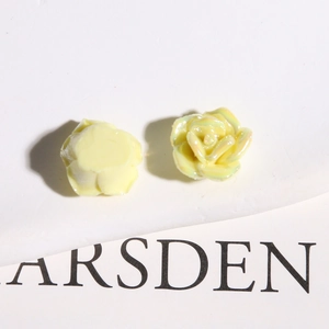 Close-up of pale yellow iridescent ceramic roses for DIY jewelry and accessories