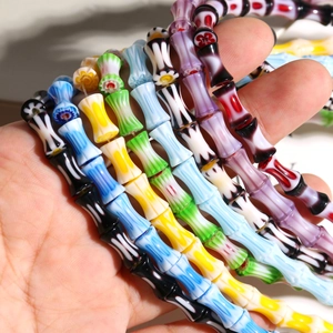 Macro view of colorful millefiori glass bamboo beads for DIY jewelry making accessories