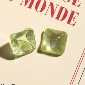Detail of square avocado green resin accessories with gold glitter and water ripple texture