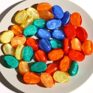 Colorful oval resin charms with liquid glitter effect for DIY jewelry making and crafts