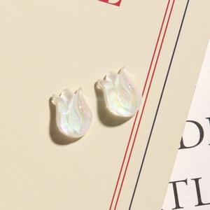 Dettaglio macro di ciondoli a tulipano in resina bianca cangiante per gioielli DIY