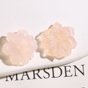 Macro view of peach resin flower accessories with fine glitter finish for DIY hairpins