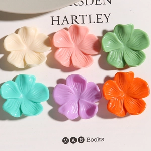 Detailed view of six colorful resin flower charms in cream and pastel tones for DIY crafts