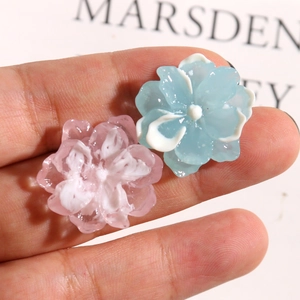 Close-up of pink and blue resin gardenia flower charms for DIY hair accessories