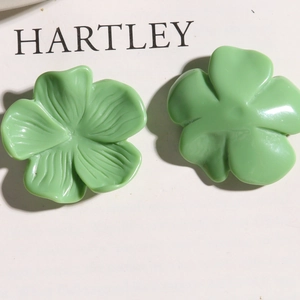 Macro detail of green resin flower petals showing front texture and smooth back surface