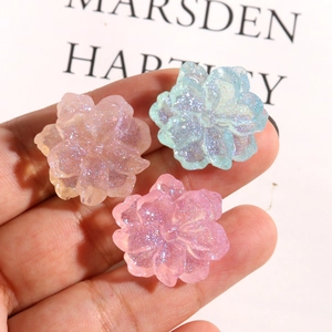 Sparkling gardenia flower resin charms in peach and blue hues for DIY hair accessories