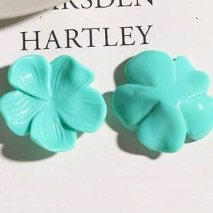 Detailed close-up of mint green resin flower charms showing delicate petal textures