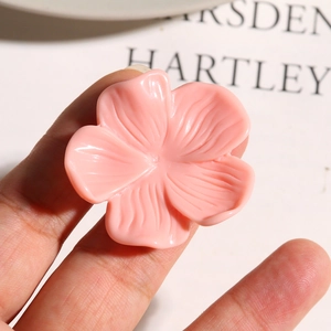 Close-up of pink resin flower charm featuring natural petal textures and matte finish