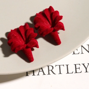 Detailed view of burgundy velvet trumpet flower charms with soft flocked texture for DIY jewelry