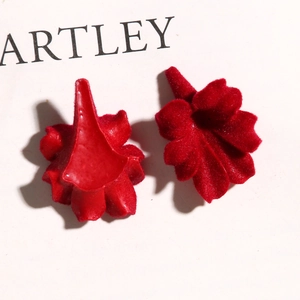 Macro detail of wine red velvet trumpet flower charms with soft flocked texture for DIY crafts