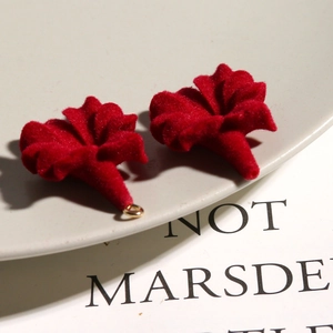 Detail of red velvet trumpet flower charms with golden loops for DIY jewelry making