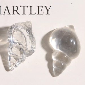 Macro detail of transparent resin sea shells with spiral textures for DIY crafts