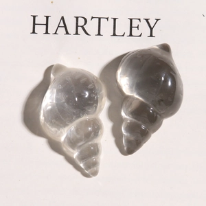 Macro detail of transparent resin sea snail charms with ice-crack texture for DIY