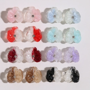 Detailed grid of resin flower charms with clear petals and small rhinestone centers in 8 colors