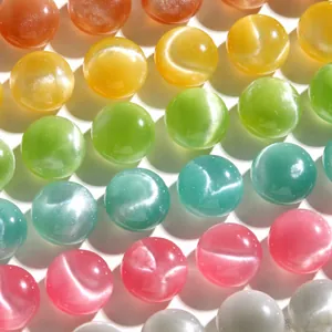 Macro view of 15mm round colorful glitter resin beads with cat-eye effect shimmer
