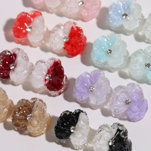 Macro shot of colorful resin flower charms with rhinestones for DIY earring making