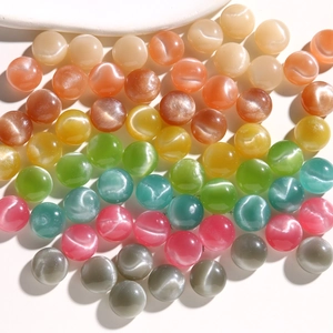 Macro detail of 15mm round cat-eye resin beads in vibrant colors for DIY jewelry crafts