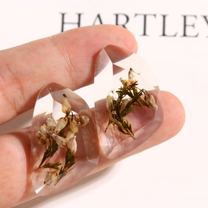 Clear faceted resin charm with preserved white flowers and green leaves for DIY crafts