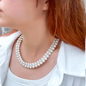 Elegant double-layered freshwater pearl necklace with sparkling zircon accents on model