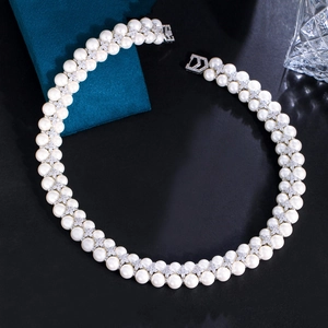 Detail of double-strand freshwater pearl necklace with zircon flower spacers and D-clasp