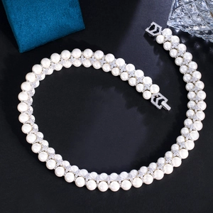 Close-up of double-layer pearl necklace with zircon cross links on black velvet